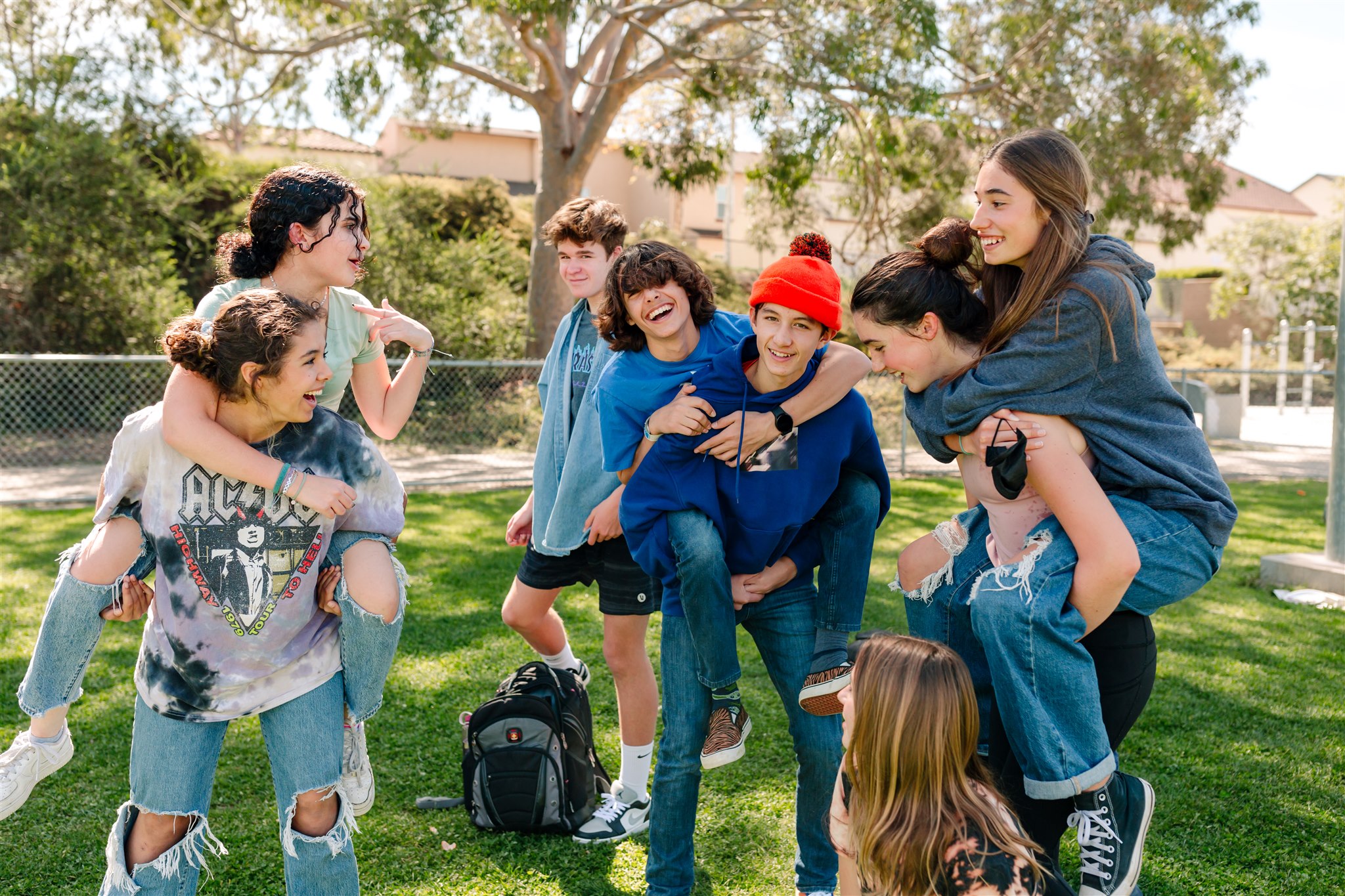 High school students at SET High in San Diego giving piggy-back rides outside
