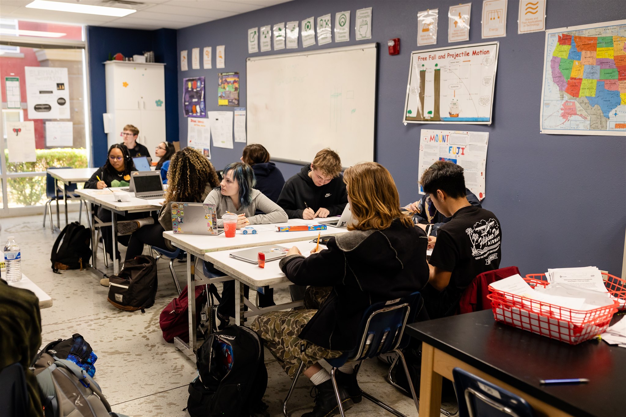 SET High students working at tables in groups inside a classroom.